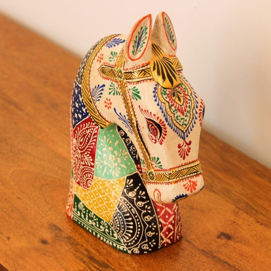 Hand Painted Folk Motif Horse Head Decor Styled on Table Hand-painted folk motif wooden horse head with a cream face placed on a wooden table as a colourful tabletop accent.