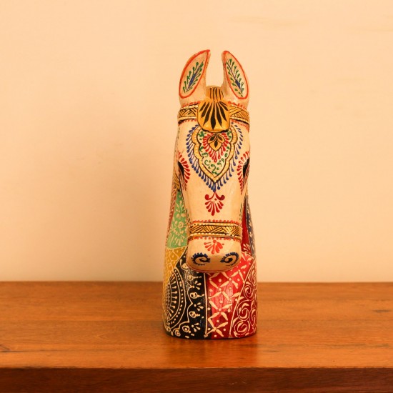 Hand Painted Folk Motif Horse Head Decor Styled on Table Hand-painted folk motif wooden horse head with a cream face placed on a wooden table as a colourful tabletop accent.