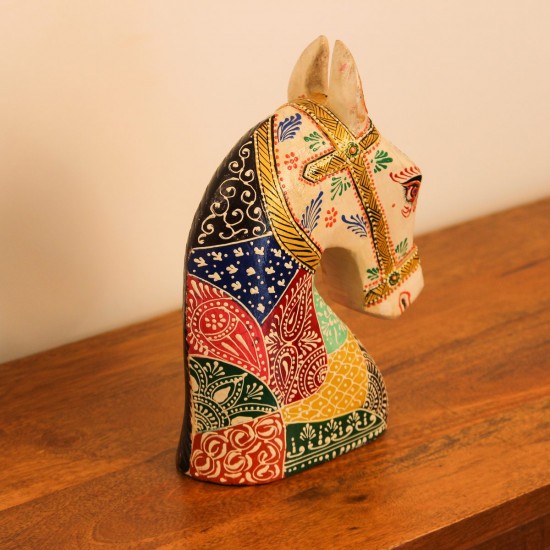 Hand Painted Folk Motif Horse Head Decor Styled on Table Hand-painted folk motif wooden horse head with a cream face placed on a wooden table as a colourful tabletop accent.