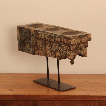Antique carved wooden candle holder on stand styled on a console
