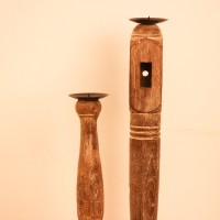 Repurposed Wooden Pillar Candle Stand – Whitewash Candle stand crafted from a repurposed antique bed leg, turned into a slender pillar form with a whitewashed distressed finish and a black metal candle plate on top.