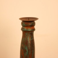 Repurposed Wooden Pillar Candle Stand – Distressed Green Candle stand crafted from a repurposed antique bed leg, turned into a slender pillar form with a distressed green finish and a black metal candle plate on top.