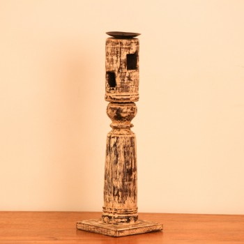 Tall candle stand crafted from a repurposed antique bed leg, finished in a white distressed tone with turned detailing and a black metal candle plate on top.