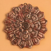 Antique Carved Mandala Wall Decor – Red Genuine antique wooden medallion carved in a radiating star-shaped mandala pattern, showing traces of original red and pink pigment across its surface.