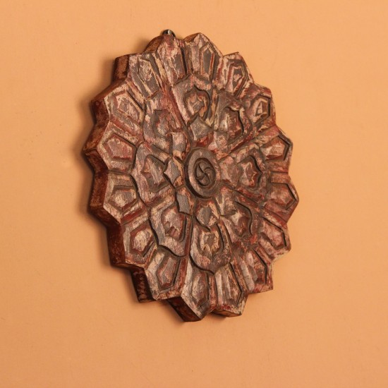 Antique Carved Mandala Wall Decor – Red Genuine antique wooden medallion carved in a radiating star-shaped mandala pattern, showing traces of original red and pink pigment across its surface.