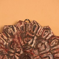 Antique Carved Mandala Wall Decor – Red Genuine antique wooden medallion carved in a radiating star-shaped mandala pattern, showing traces of original red and pink pigment across its surface.