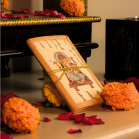 Calligraphy Bahi Khata Journal Ganesha Ji Handmade Ganesha Bahi Khata diary placed near pooja setup with marigold flowers and diya
